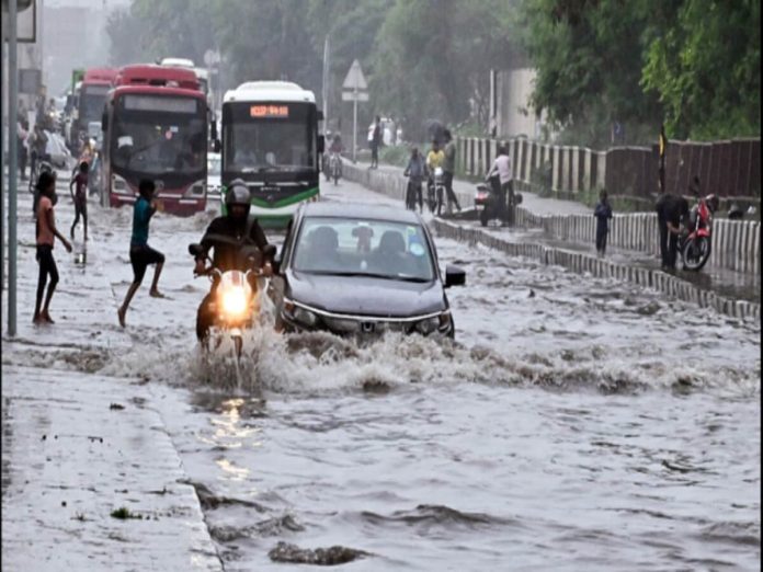 delhi_vehicles_wade_through_the_waterlogged_road_during_heavy_rainfall_in_new_delhi_on_saturday__1688864159